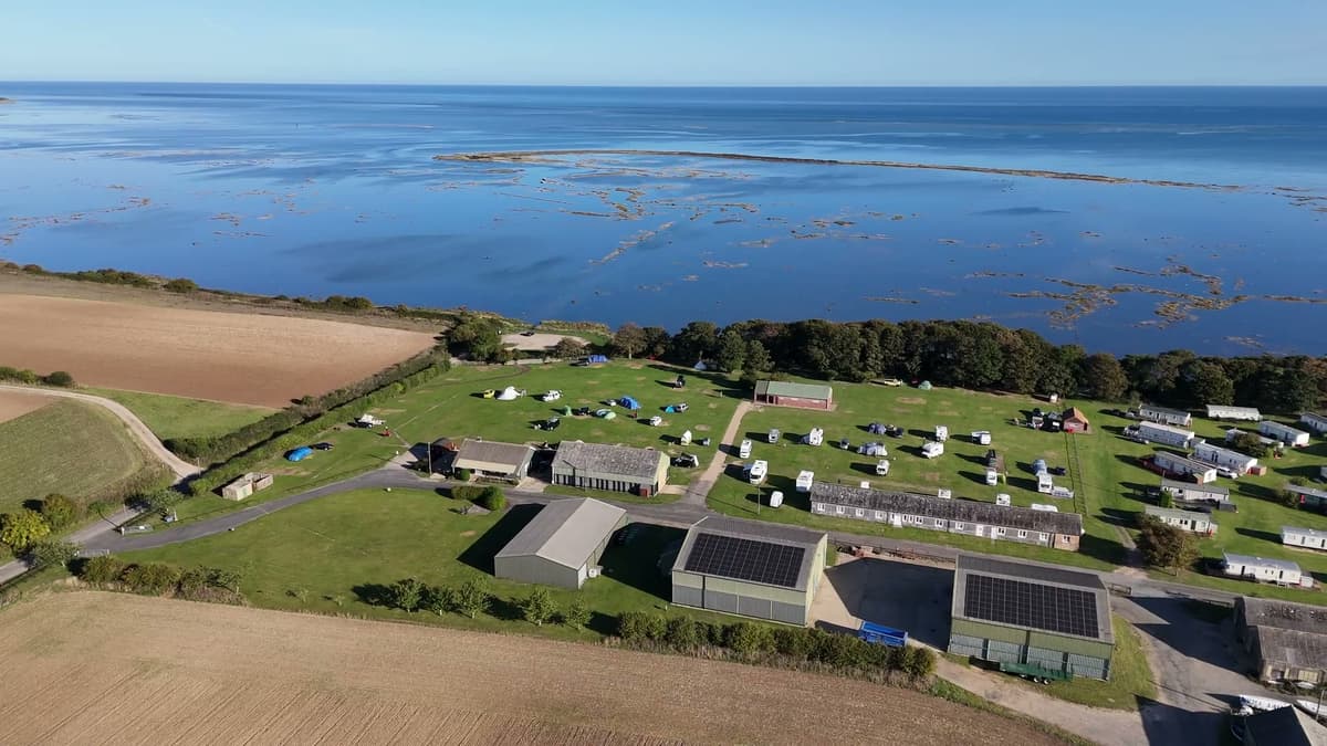 The campsite from the air, with the marsh and the sea behind